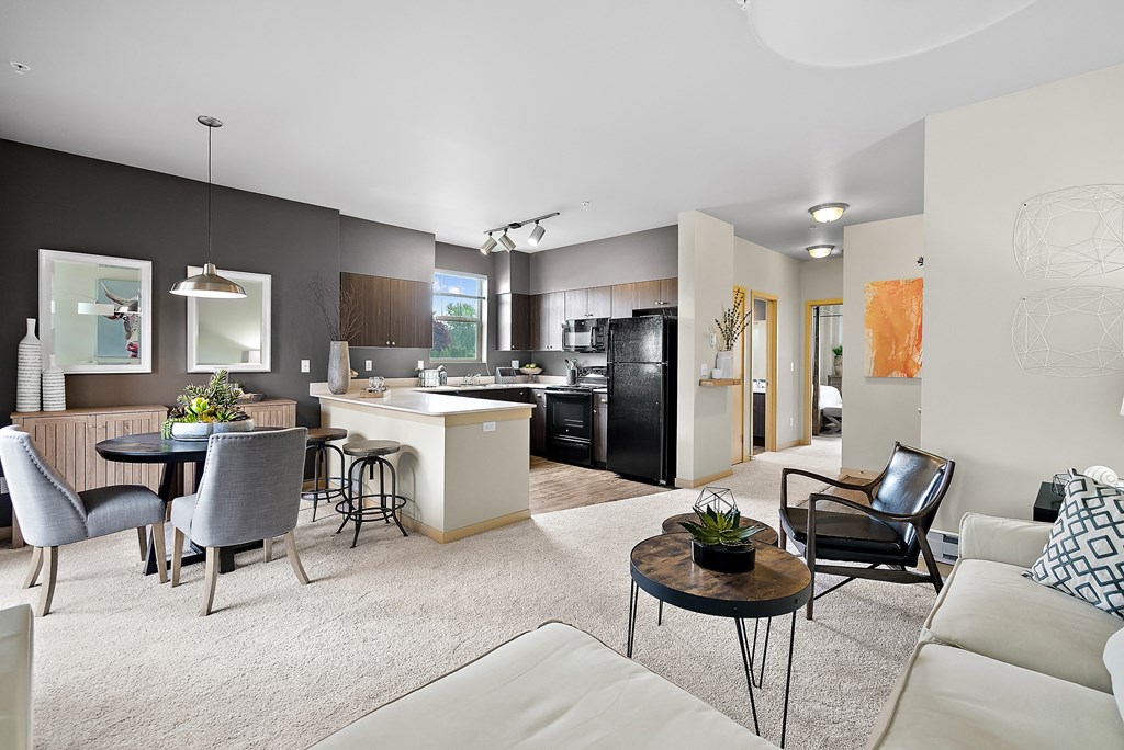 an open living room with a kitchen and dining room