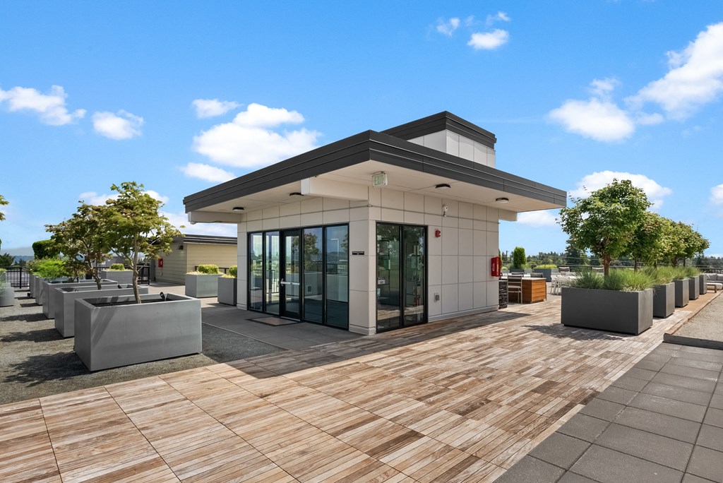 a building with glass doors and a wooden deck