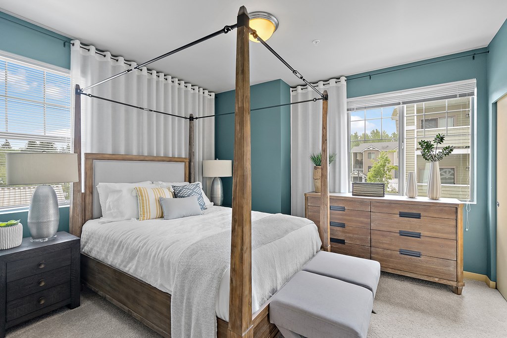 a bedroom with a bed and a dresser and a window