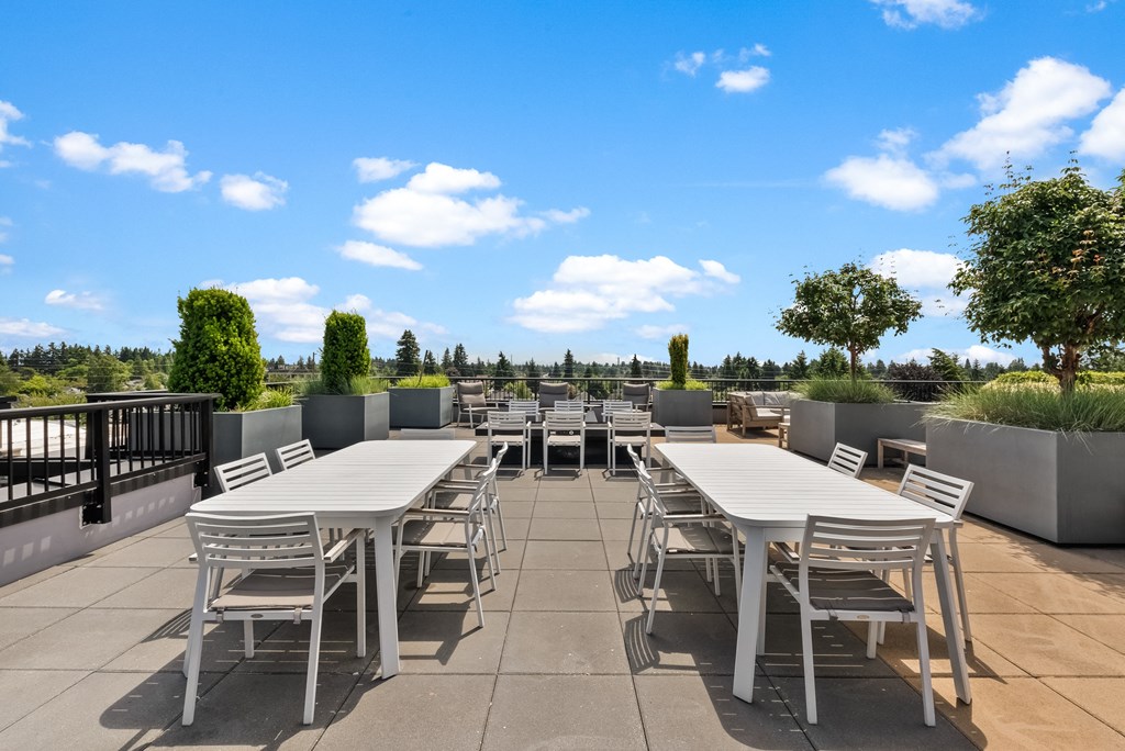 a patio with tables and chairs on a roof