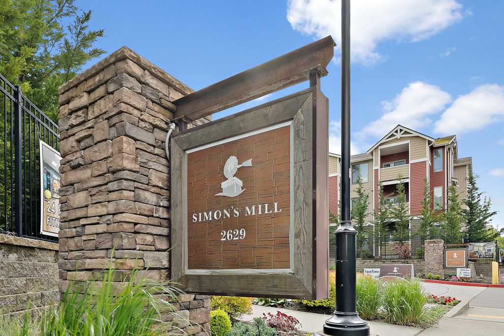 a sign for the entrance in front of a building