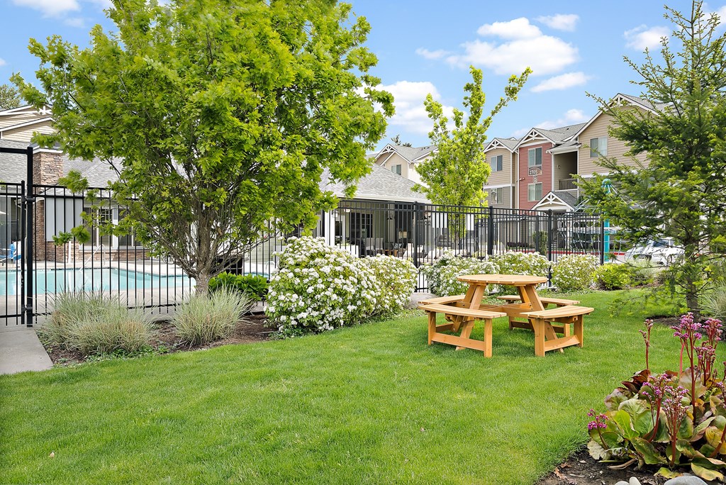 a backyard with a picnic table and a pool