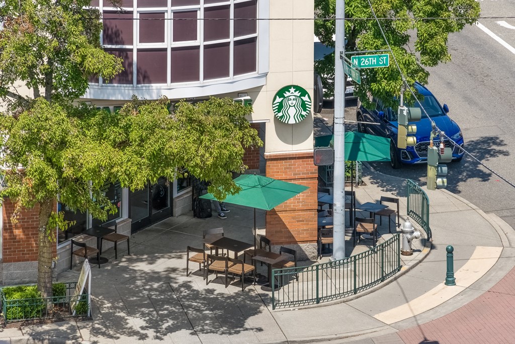 an aerial view of a building with a starbucks sign on the side of it