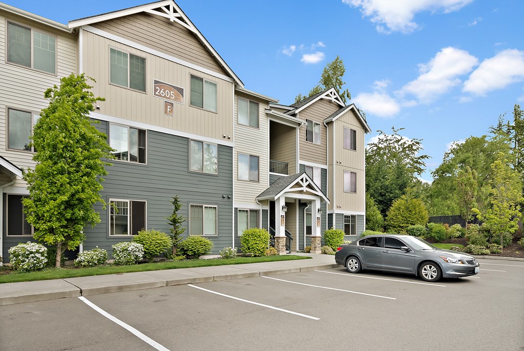 a car parked in front of an apartment building