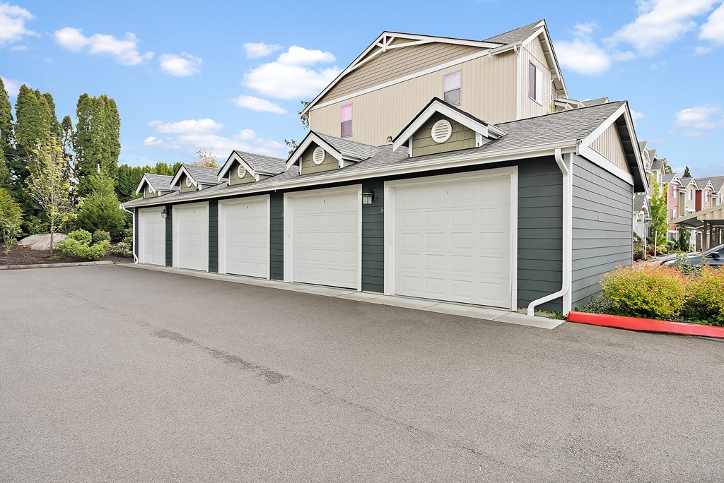 a row of garage doors on the side of a house