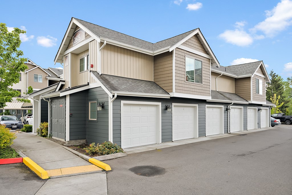 the front of a house with two garage doors