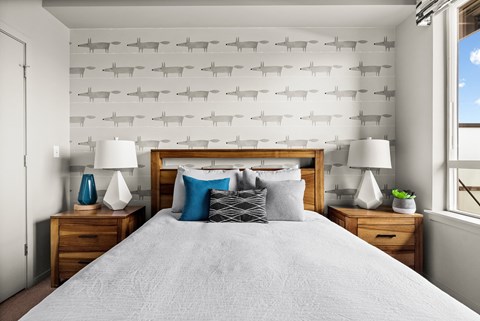 a bedroom with a bed and a wall with planes on it