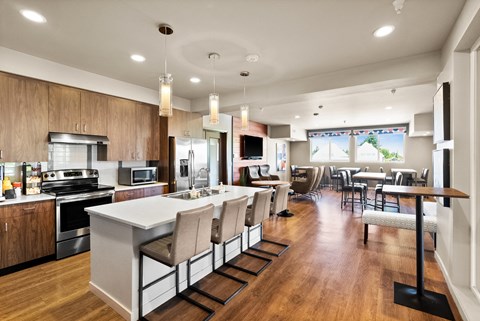 an open kitchen and dining room with a large island and chairs