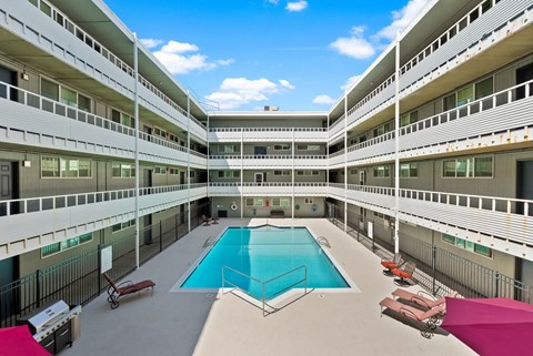 an exterior view of a large building with a swimming pool