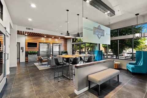 the preserve at ballantyne commons clubhouse with a bar and tables with chairs
