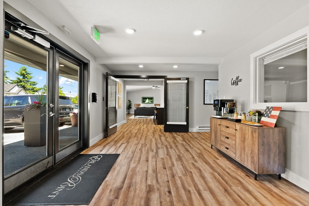 a living room with a hard wood floor and glass doors