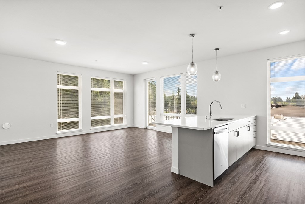 a living area with hardwood floors and white walls
