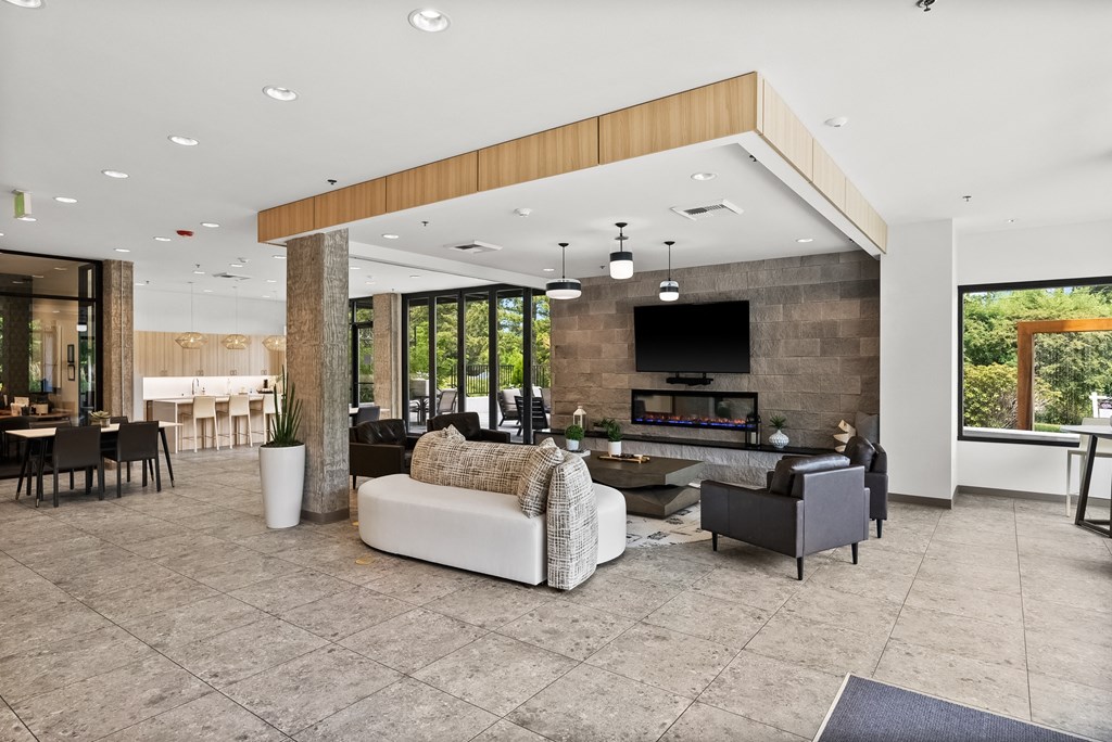 a living room filled with furniture and a large window