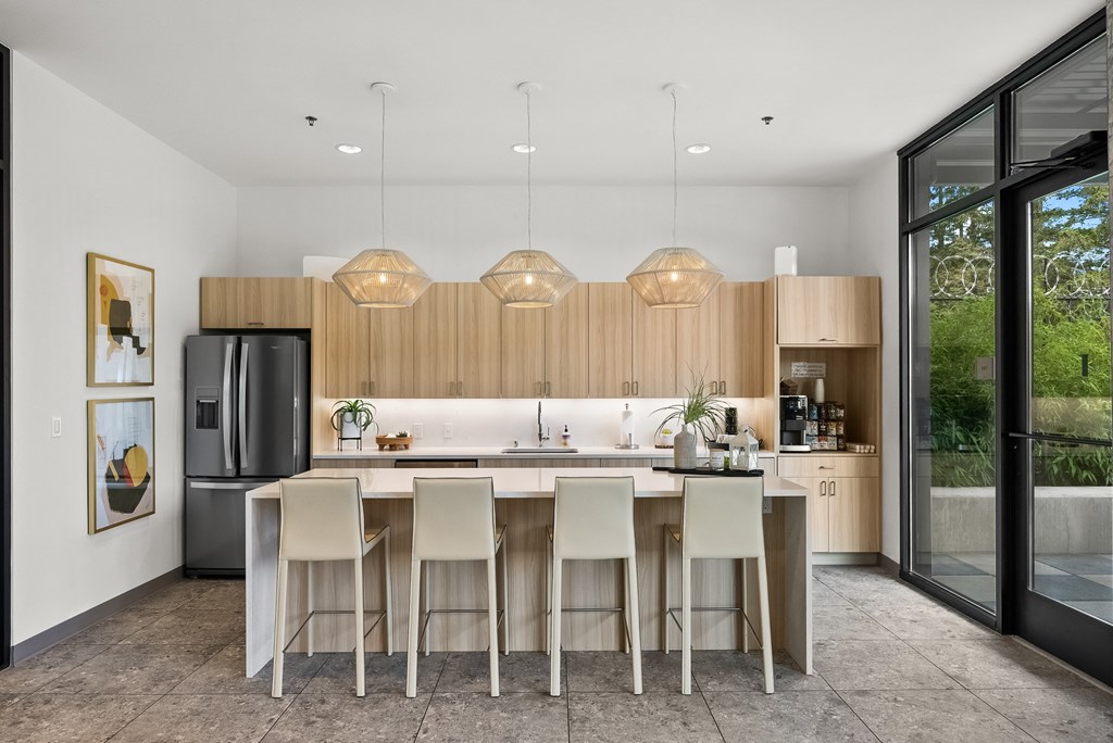 a kitchen with wooden cabinets and a large island with stools