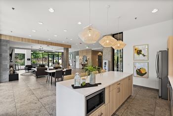 A modern kitchen with a white island and wooden cabinets.