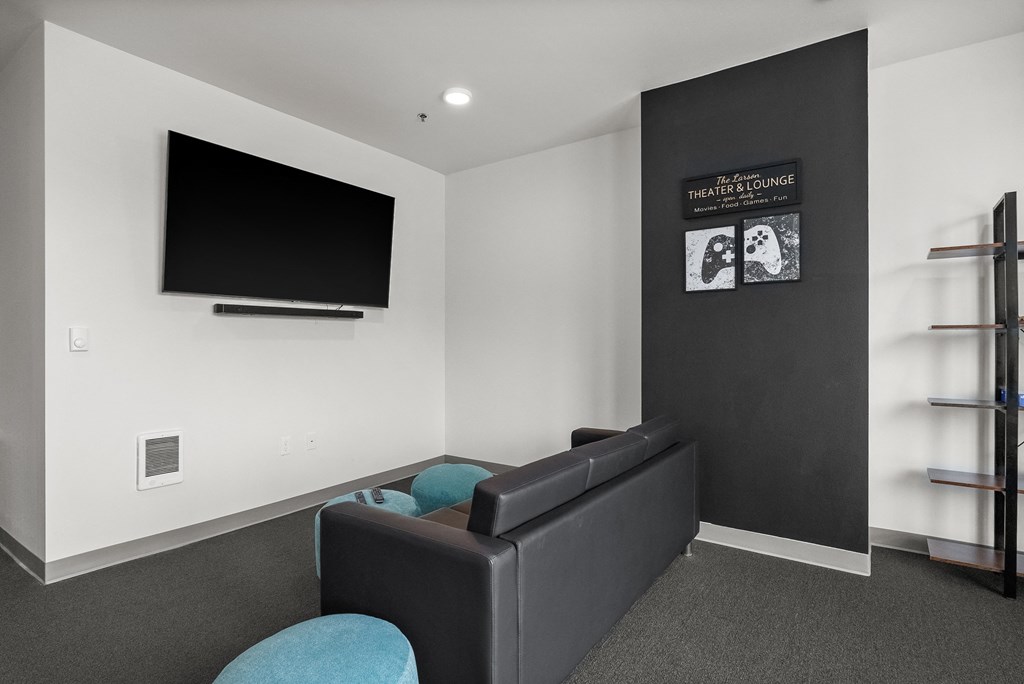a living room with a couch and a tv on the wall