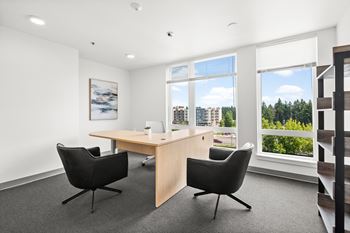 A room with a desk and two chairs.