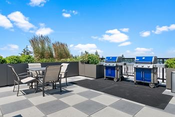 A patio with a table and chairs and a blue and white machine.