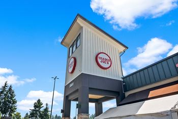 A Trade Joe's storefront with a blue sky in the background.