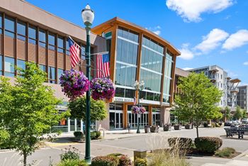 A street view of a building with a flag pole in front of it.