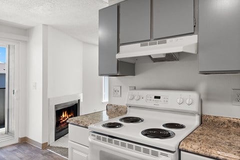 a kitchen with a stove and a fireplace