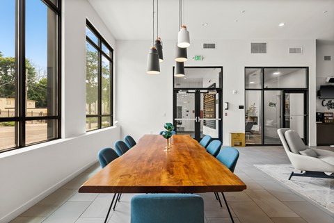 A conference room with a long table and chairs.