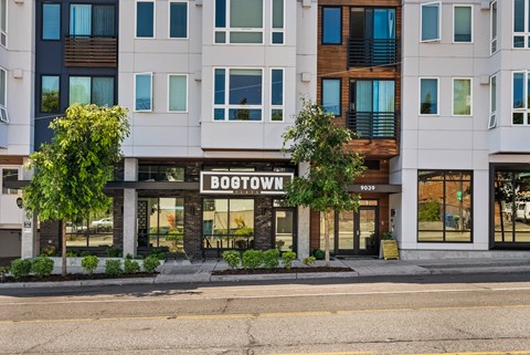 A white building with the name BOOSTOWN on the front.