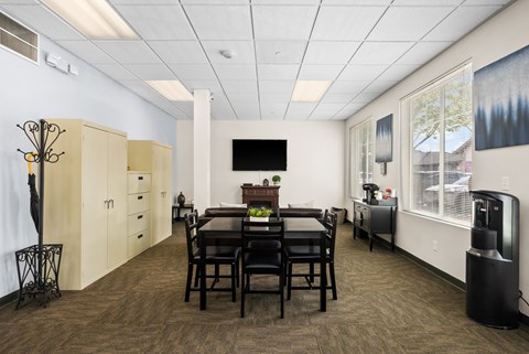 a dining room with a table and chairs in front of a large window