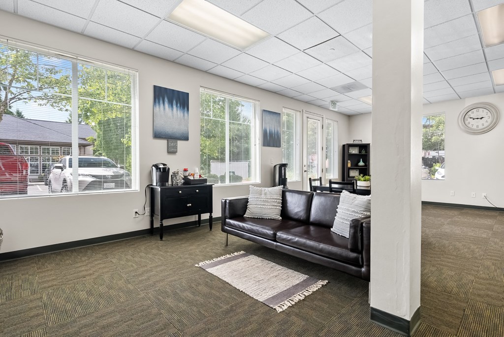 a living room with a leather couch and a window