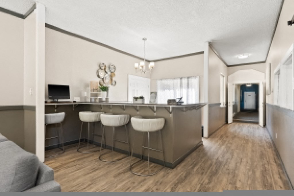 a kitchen with a bar and a living room with a couch