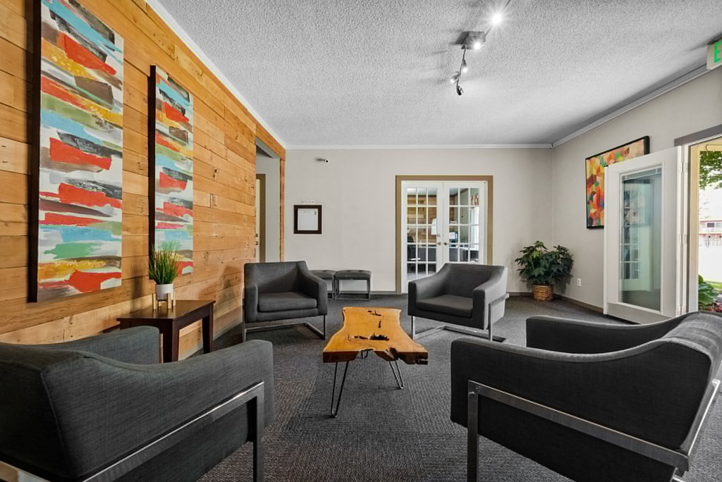 a living room with chairs and a coffee table