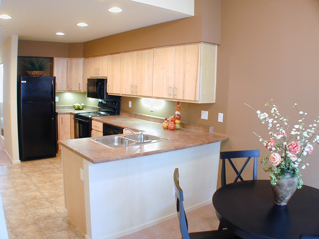 an empty kitchen with a table and a sink
