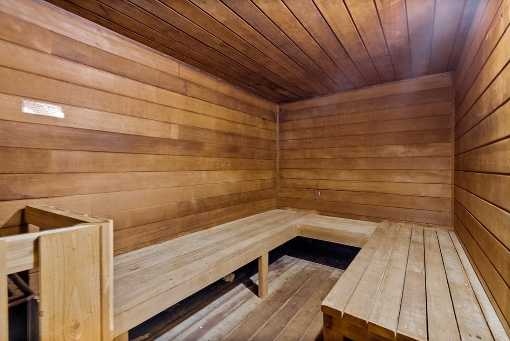 a wooden sauna with wooden floors and benches