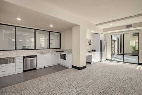 A spacious kitchen with white cabinets and stainless steel appliances.