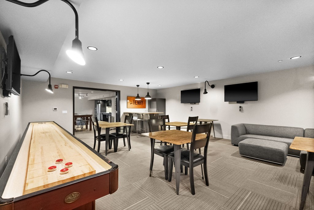 A room with a pool table and a couch.