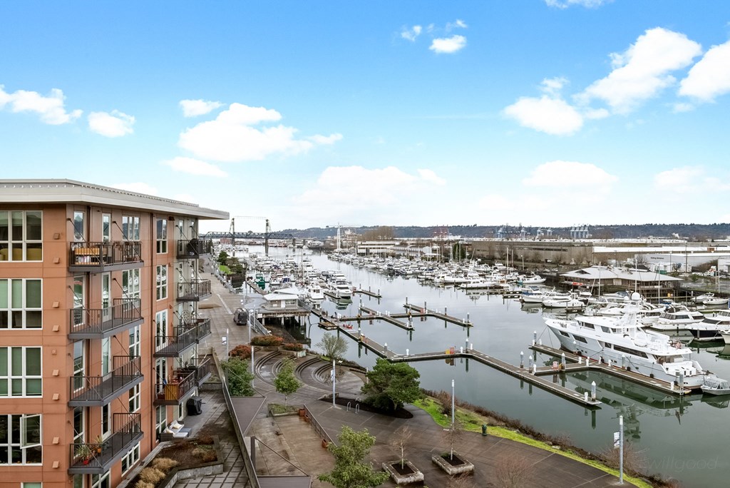 A marina with boats docked is visible from a high-rise building.at The Henry, Tacoma, 98402
