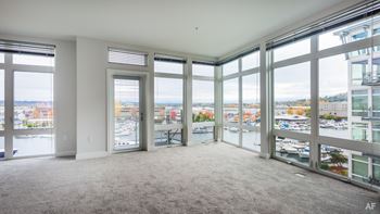 A large empty room with a view of the city.