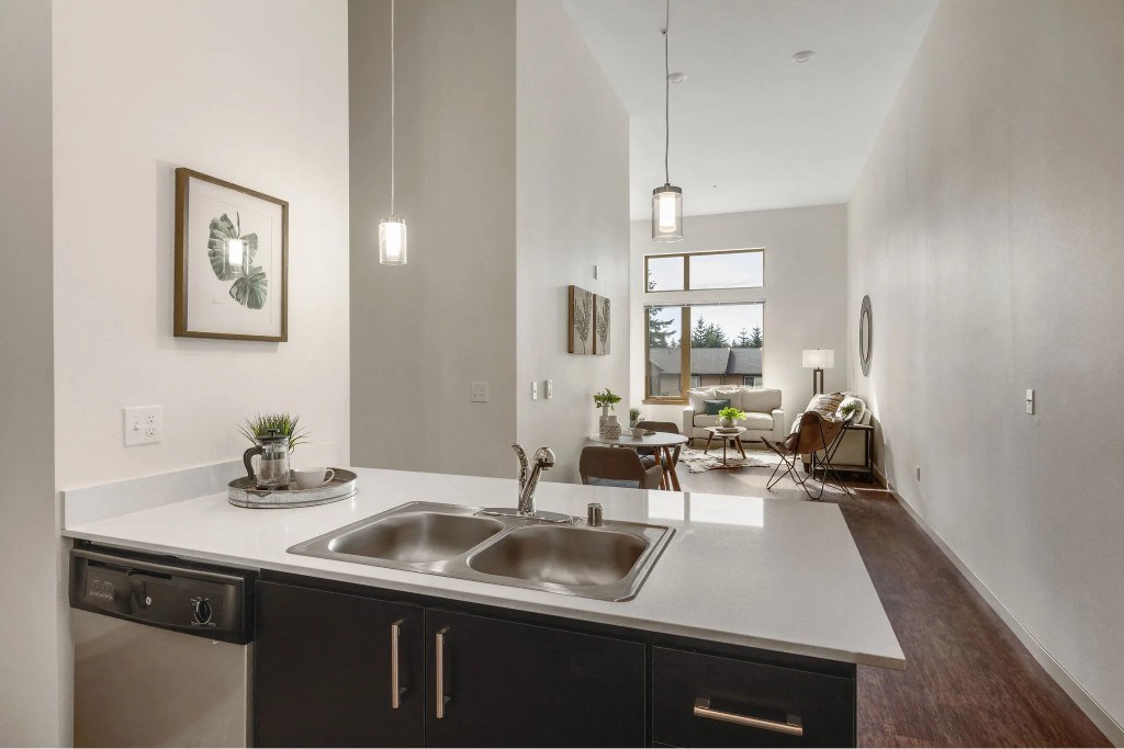 A modern kitchen with a large island and a view of the backyard.