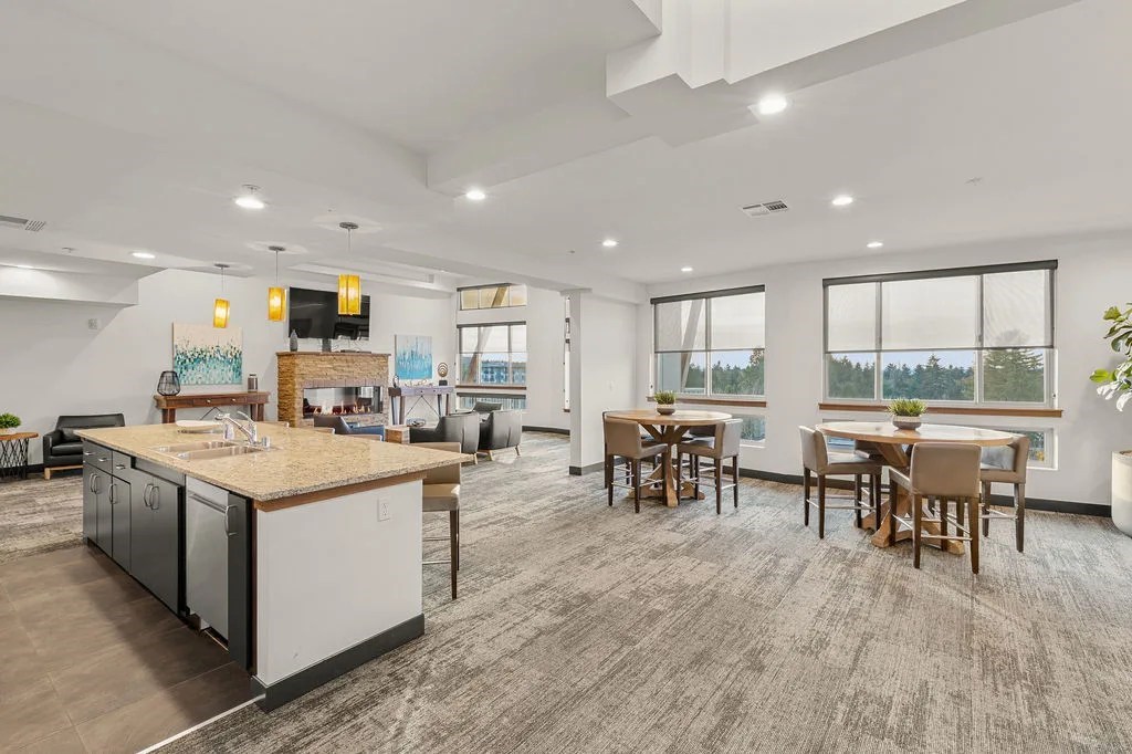 A modern kitchen with a dining table and chairs.