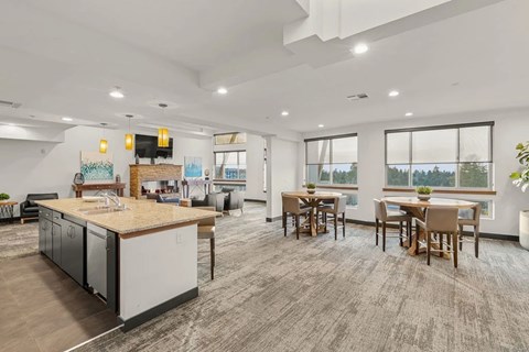 A modern kitchen with a dining table and chairs.