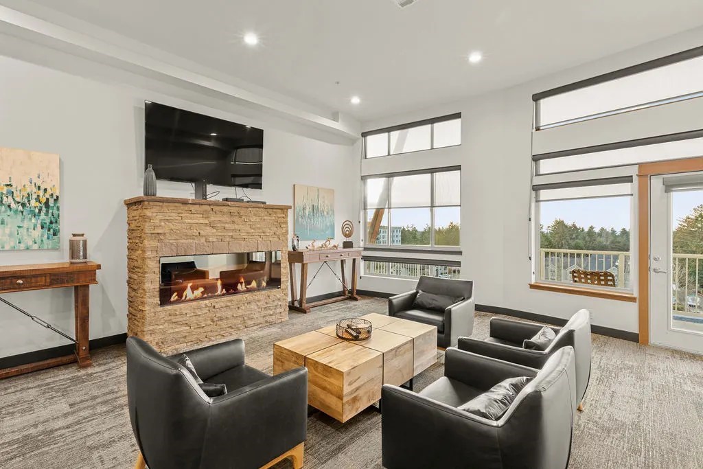 A living room with a fireplace and a balcony.