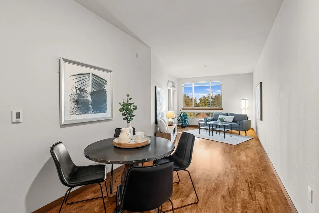 A dining room with a table and chairs.