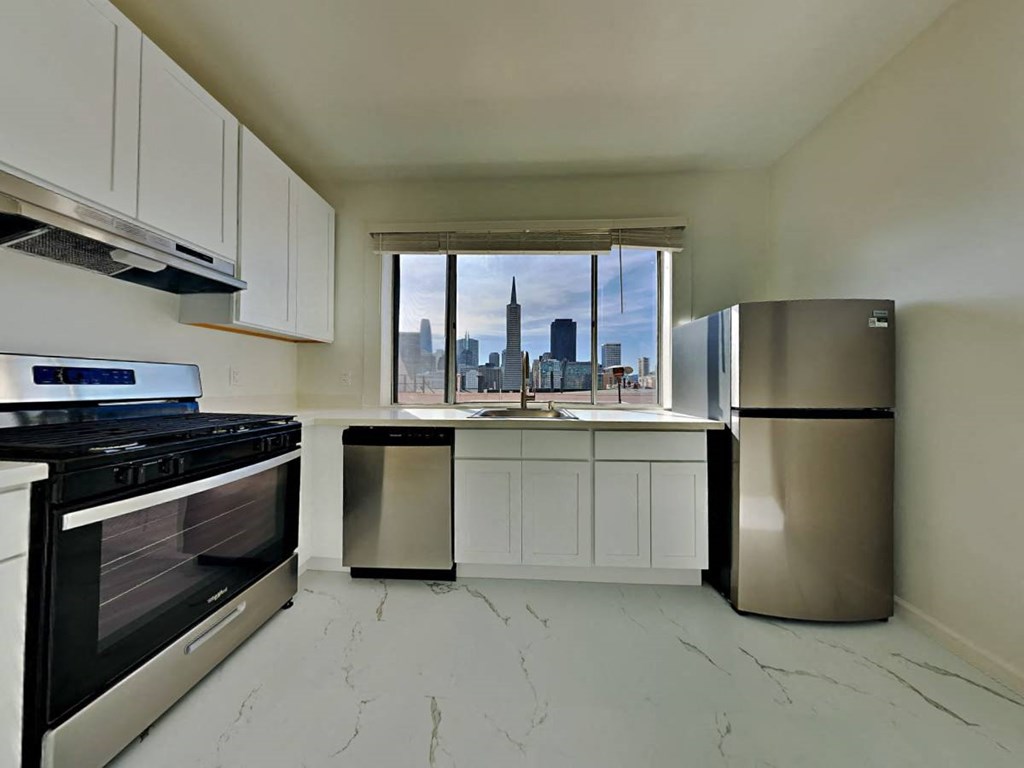 a kitchen with stainless steel appliances and a window