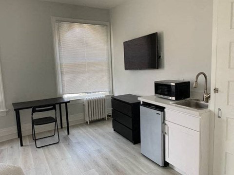 a small kitchen with a microwave and a table