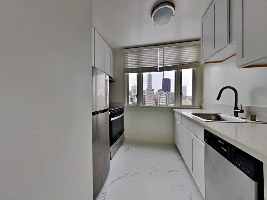 an empty kitchen with a sink and a window