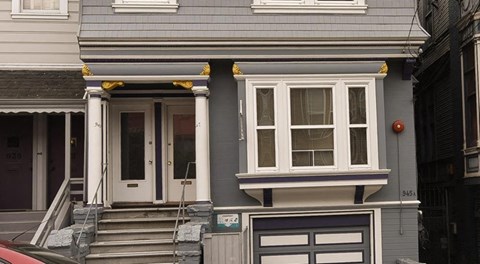 a blue house with a front door and steps