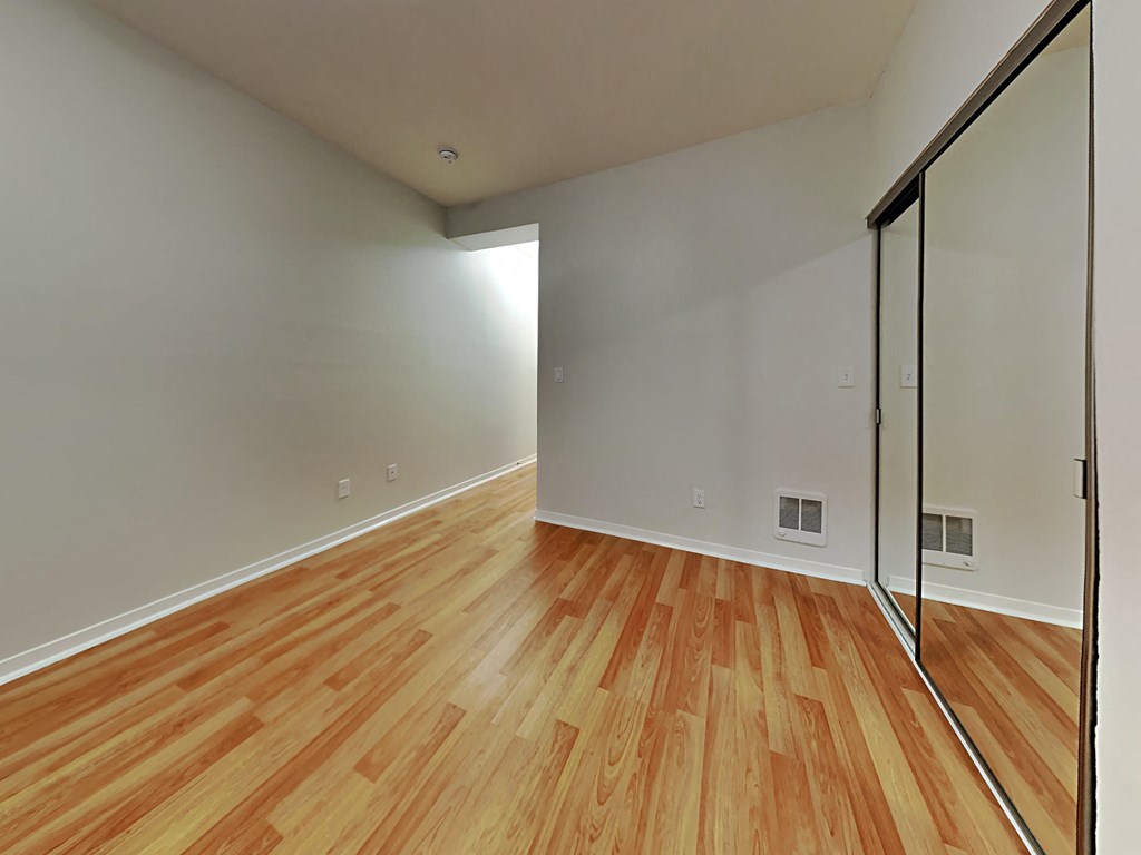 a room with wood flooring and a sliding glass door