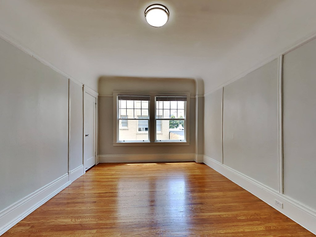 a empty room with white walls and a window