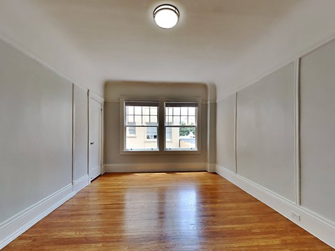 a empty room with white walls and a window