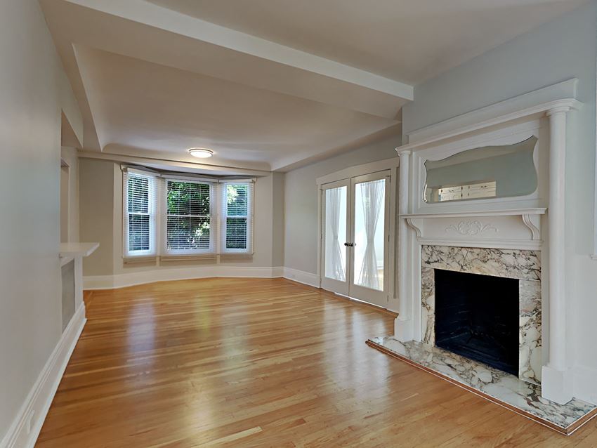 a living room with a fireplace and a wooden floor